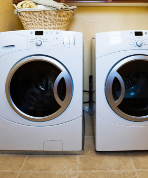 A couple of washing machines sitting next to each other