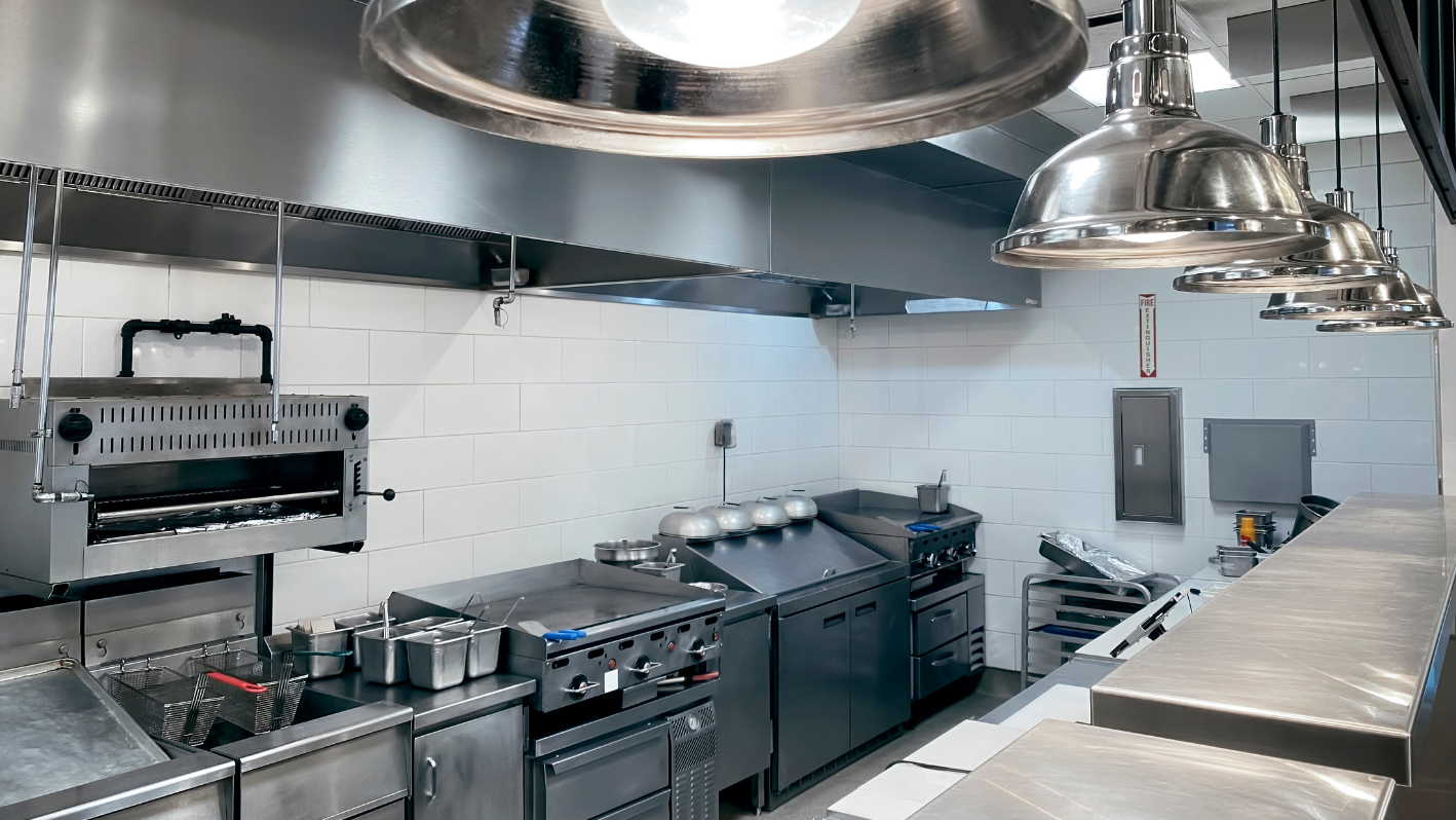 A large commercial kitchen with stainless steel appliances